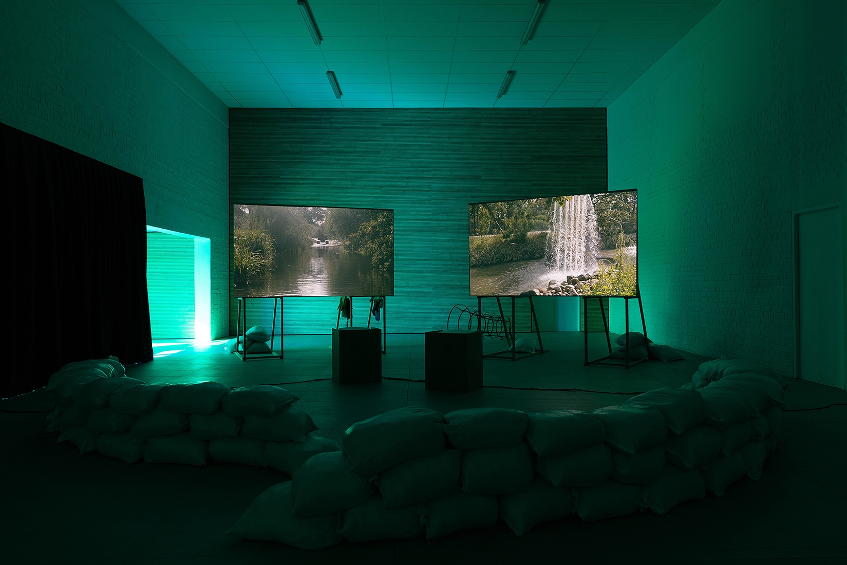 http://mail.abrideswardt.com/files/gimgs/th-81_Installation view Abri de Swardt, Kammakamma (2022-2024), Synchronised two-channel projection, configurable screens, sand from Macassar Dunes, and costumes, 16’54 min 3.jpg